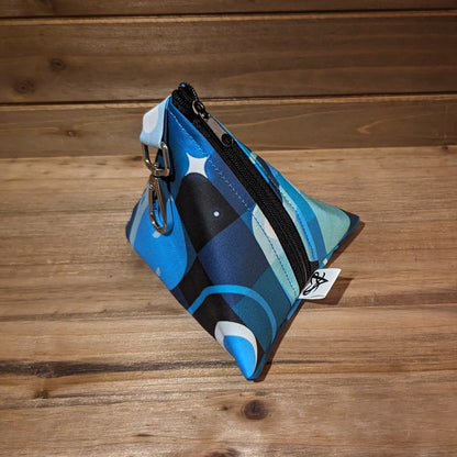 A D4 bag with blue toned rockets flying through tonal squares around planets and stars.