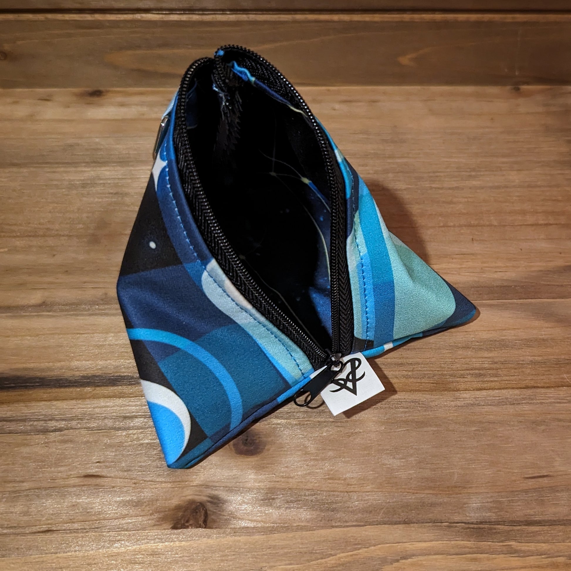 The Fractal Space D4 bag is open to show the stained glass style galaxy liner.