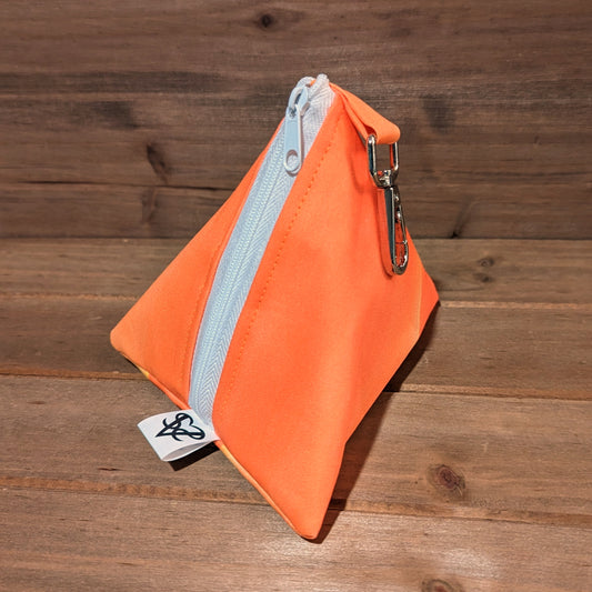 An orange 5 inch D4 bag has a white zipper and a keychain clip.