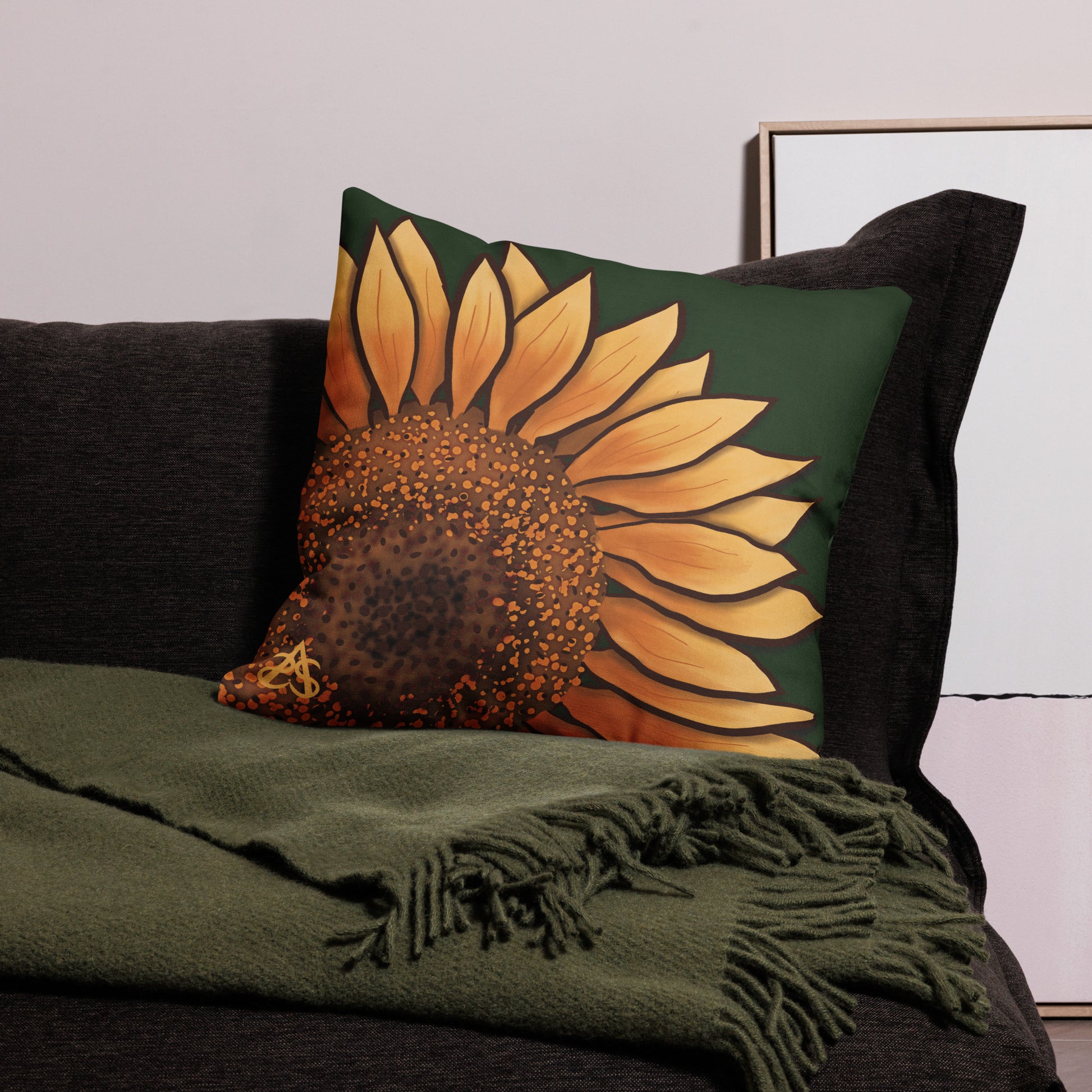 A large square pillow with a hand painted sunflower by Aras Sivad on a dark green background.