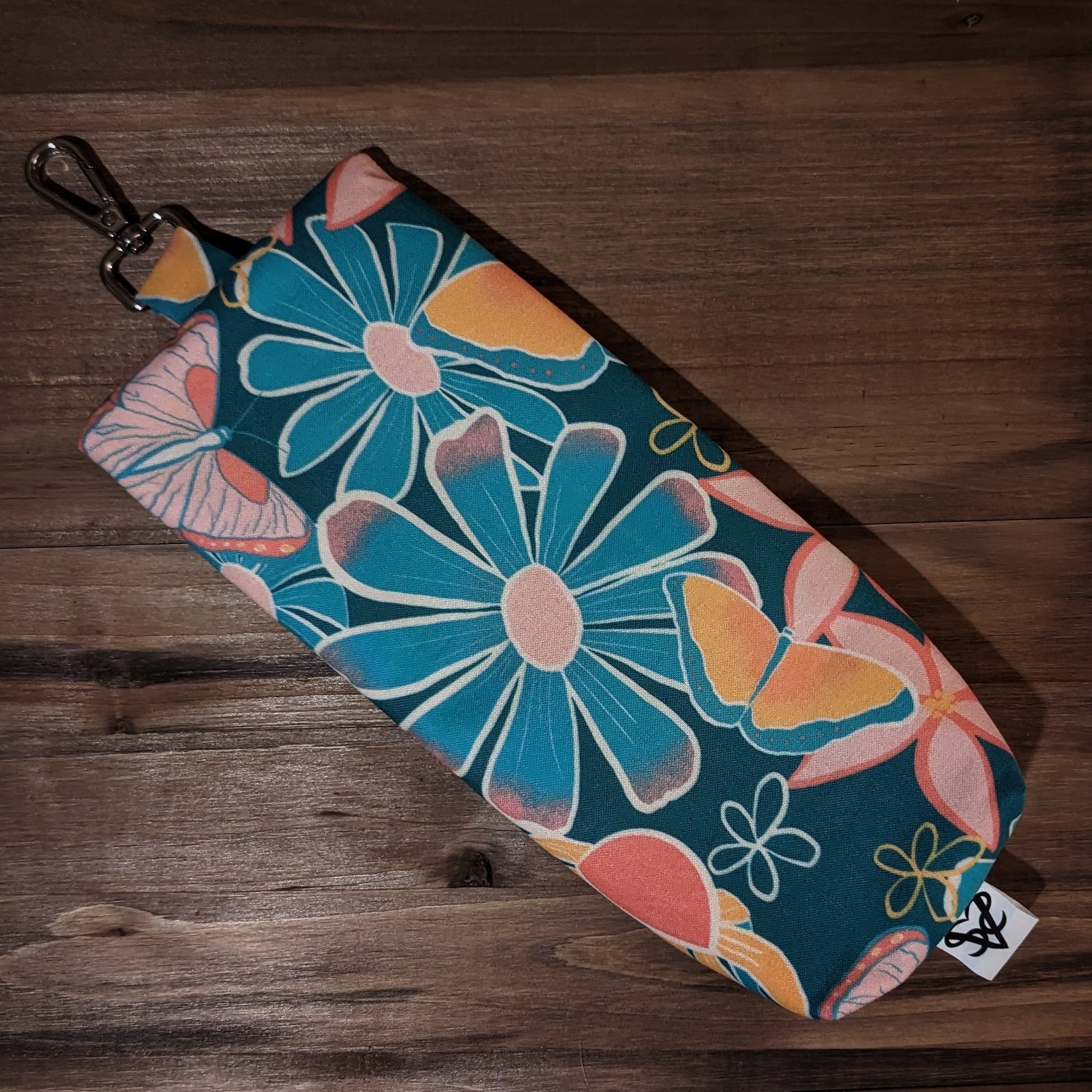 The back of the Butterfly Garden hanging case in shades of teal, yellow, pink, and white.