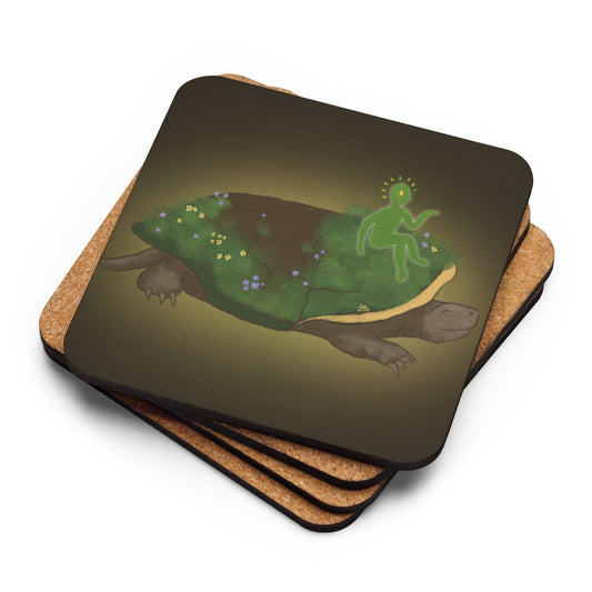 A stack of cork back coasters sit with the top one's design face up to show a turtle with grass and flowers growing on it, particularly verdant around a glowing green and yellow figure sitting near the front.