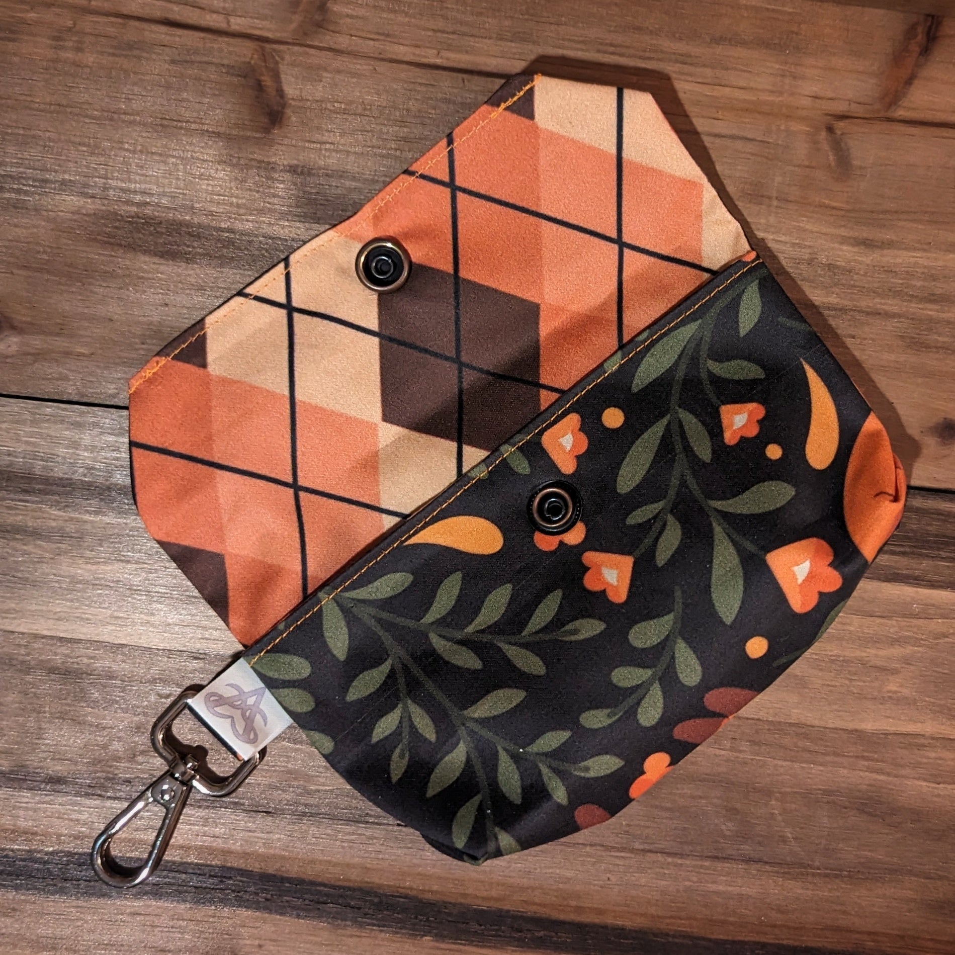 The cozy foxes tarot case open to show the brass snap inside and the peach and brown argyle liner.