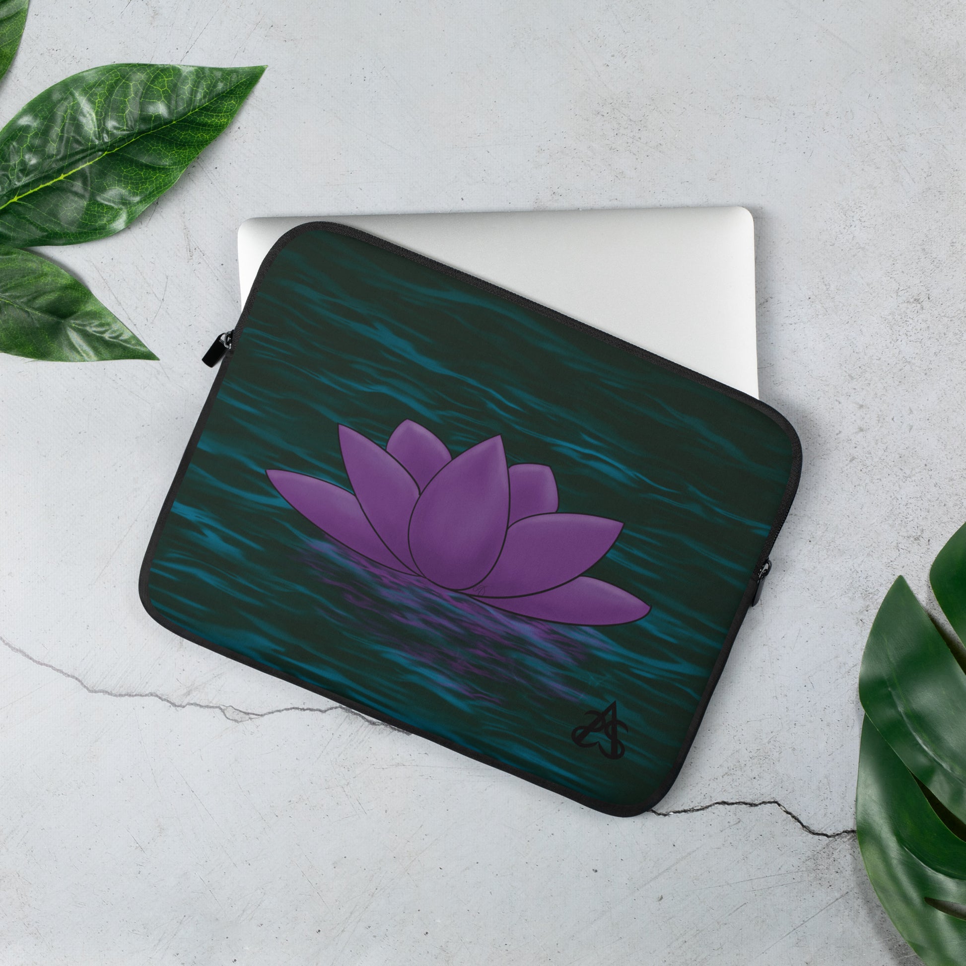 A laptop sleeve with a purple lotus flower on blue-green water.