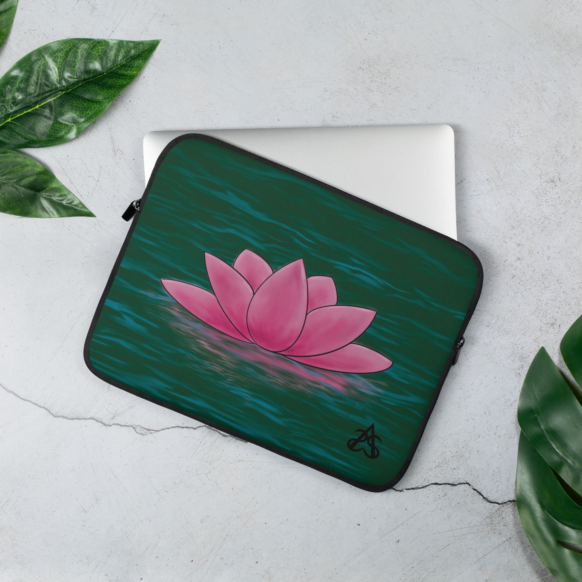 A laptop sleeve with a pink lotus flower on blue-green water.