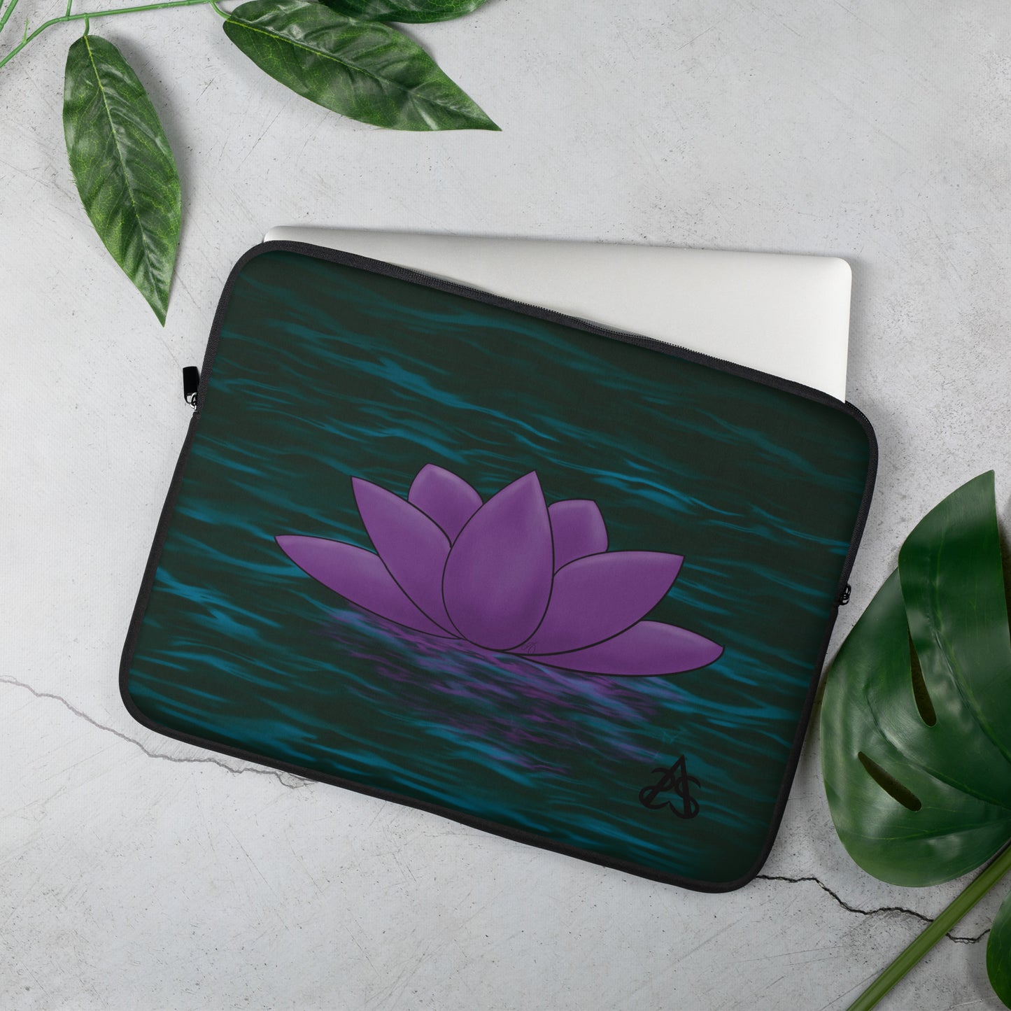 A laptop sleeve with a purple lotus flower on blue-green water.