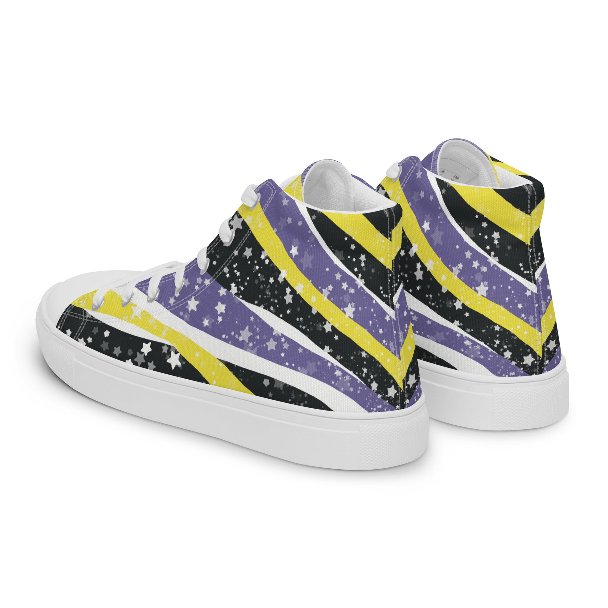 Left back view: a pair of high-top shoes with ribbons of the yellow, purple, and black of the non-binary pride flag coming from the heel and expanding towards the laces with an explosion of stars over it, white accents, and the Aras Sivad Studio logo in black on the tongue.
