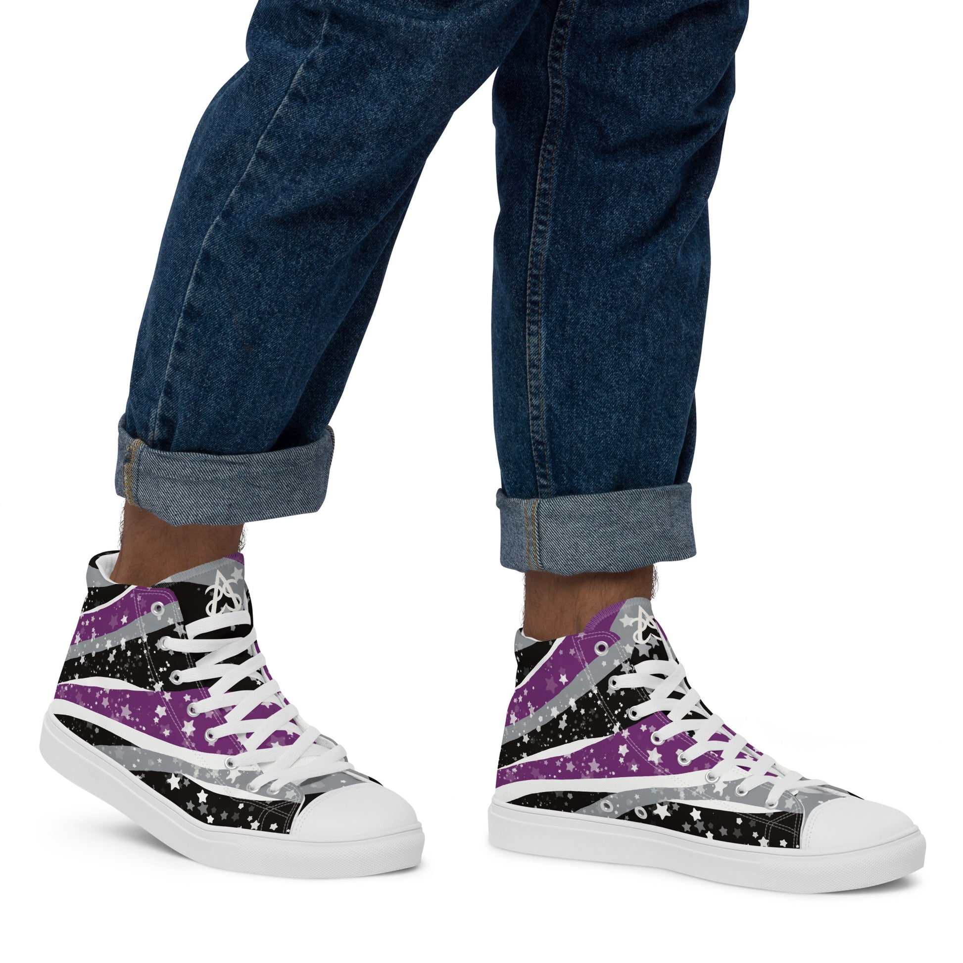 A model wears rolled up jeans and a pair of high-top shoes with ribbons of purple, grey, black, and white seem to expand from the heel to the laces with an explosion of stars.