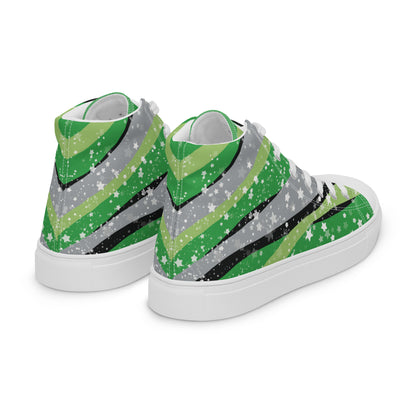 Right back view: a pair of high-top shoes with ribbons of the greens, grey, and black of the aromantic pride flag coming from the heel and expanding towards the laces with an explosion of stars over it, white accents, and the Aras Sivad Studio logo in white on the tongue.