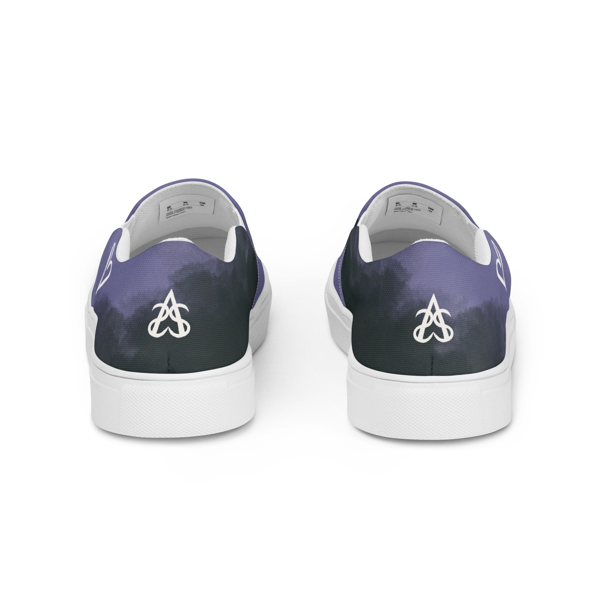 Back view: pair of slip-on shoes with the non-binary colors in wisps of clouds with a white hand drawn heart on the outside under the ankle and the Aras Sivad Studio logo in white on the back.