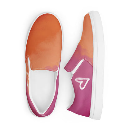 A pair of slip on canvas shoes with the colors of the lesbian pride flag in a cloudy texture, a white heart on the side, and the Aras Sivad logo on the back.