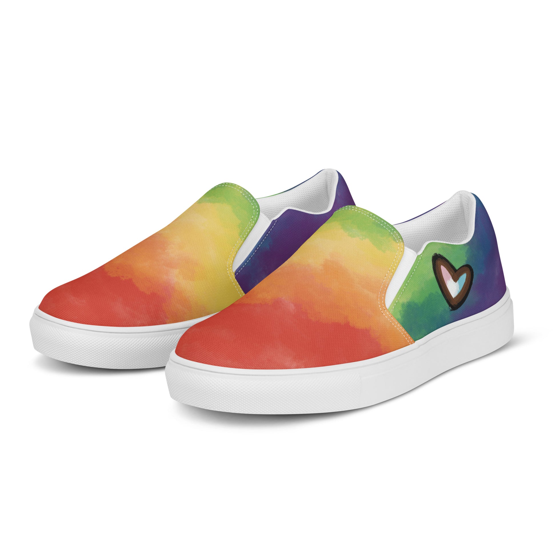 Left front view: A pair of slip on shoes with rainbow clouds wrapping around the shoe, a double heart in black and brown with the trans pride flag inside, and the Aras Sivad Studio logo on the back of the heel.