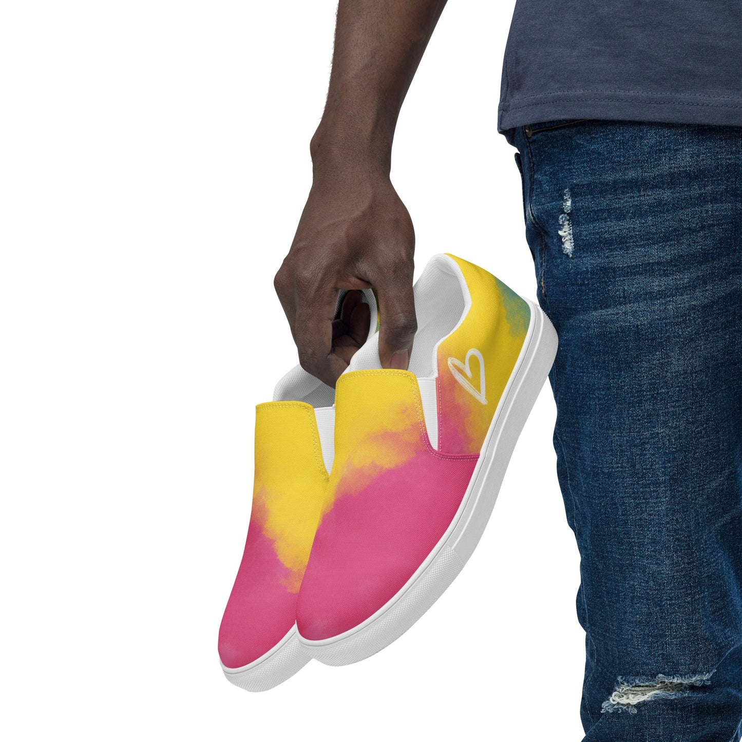 A model holds a pair of slip on shoes with color block pink, yellow, and blue clouds, a white hand drawn heart, and the Aras Sivad logo on the back.