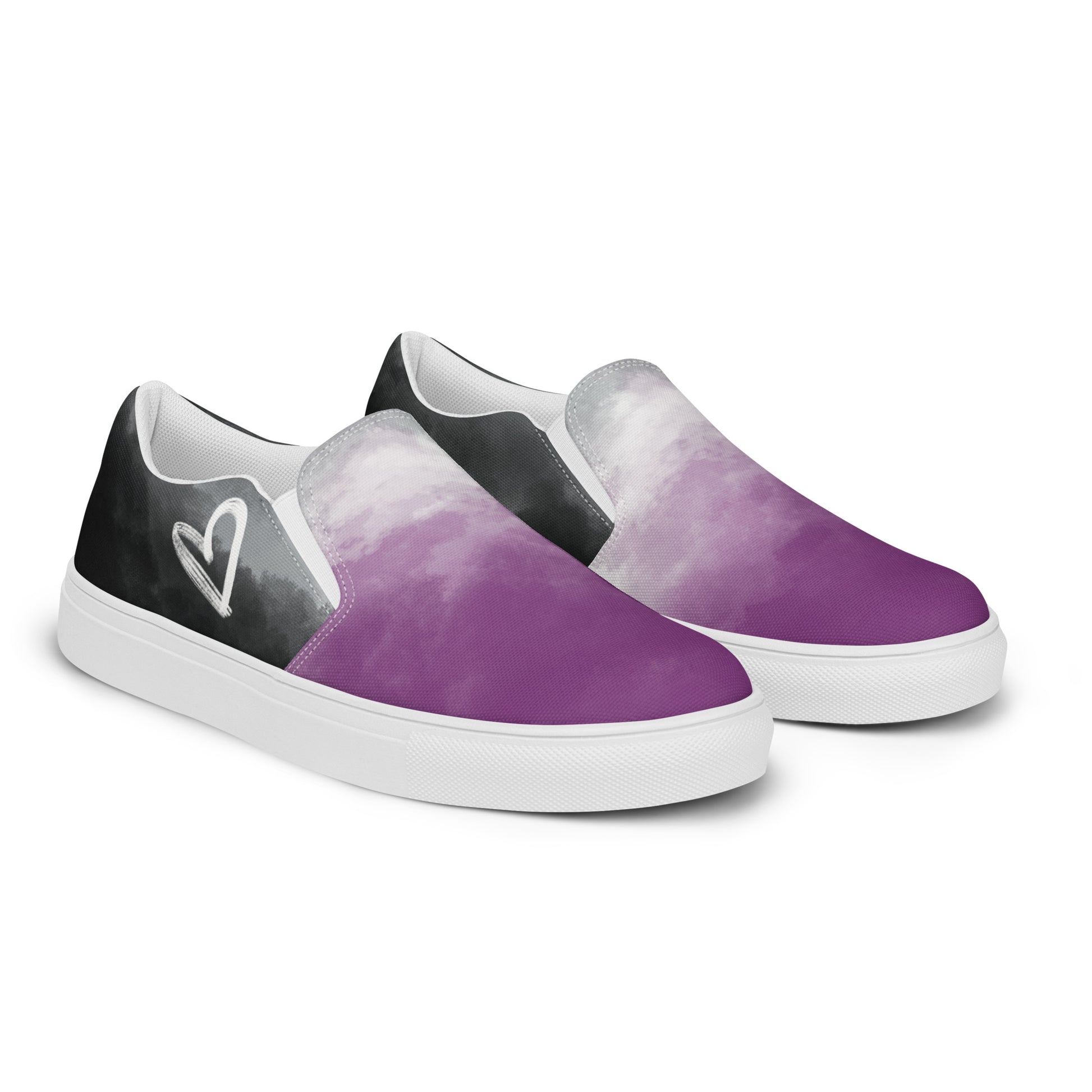 Right front view: A pair of slip-on shoes with clouds in the asexual flag colors, a hand drawn white heart on the side, and the Aras Sivad Studio logo on the back.
