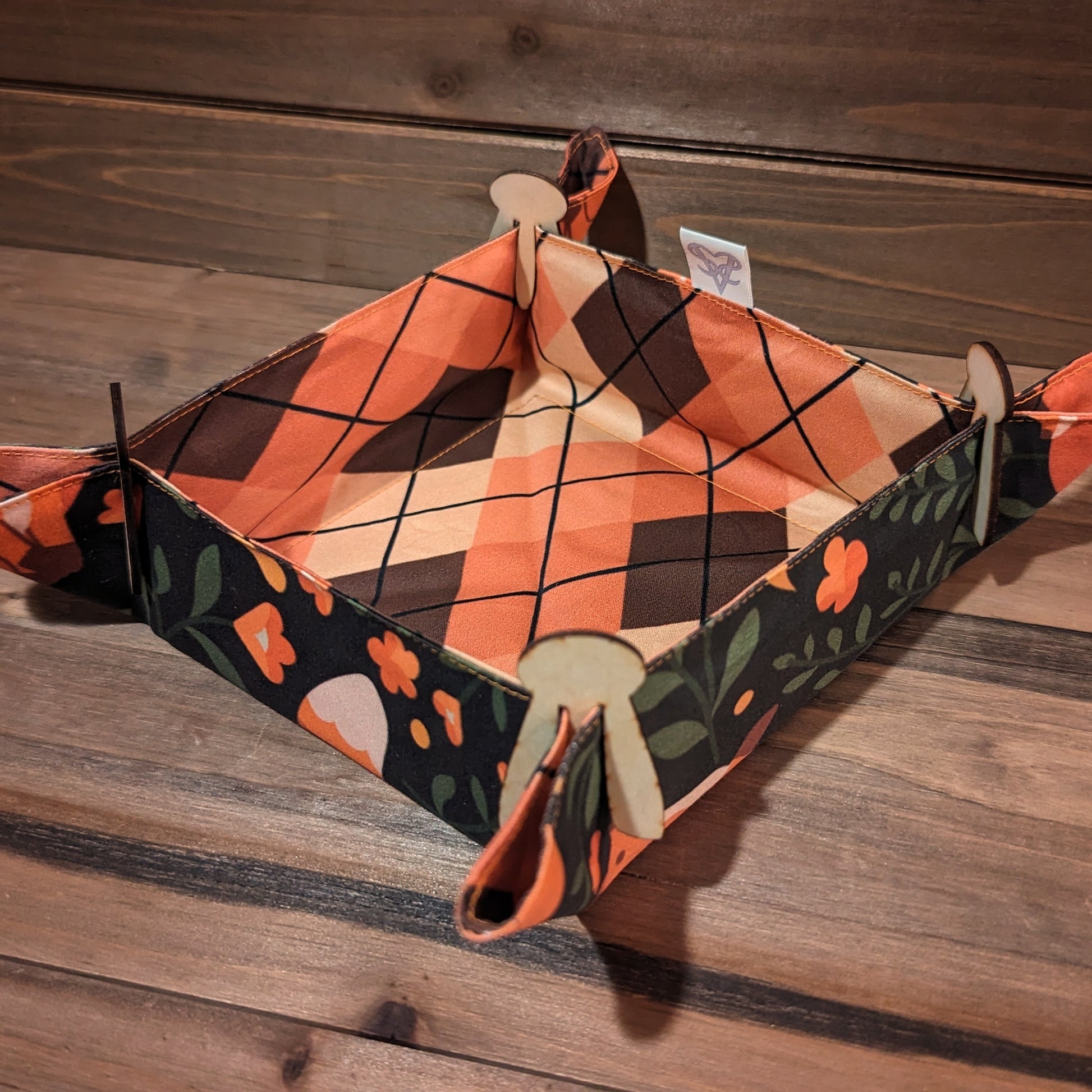 The Cozy Foxes pocket tray set up with the argyle print inside and wood clips in the corners.