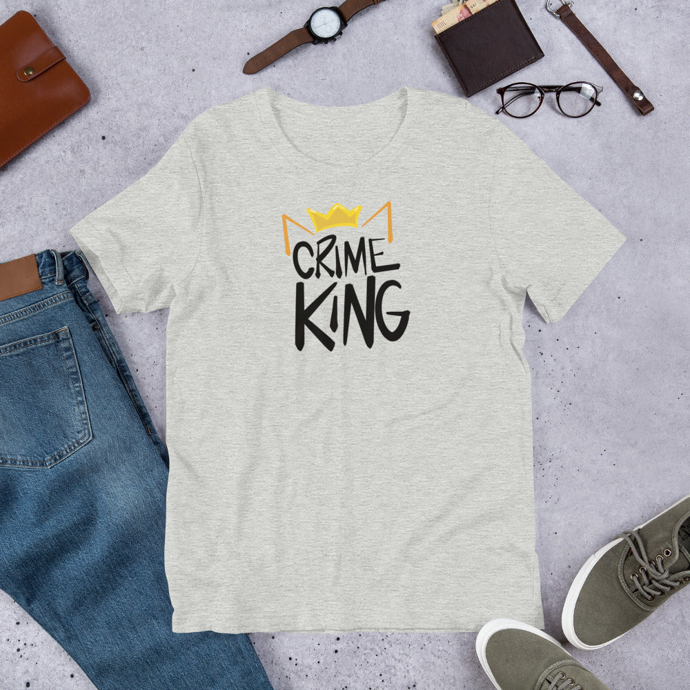A light grey heather crew neck tee shirt has a pair of orange cat ears and yellow crown sitting on the words, "Crime King" in a bold writing.
