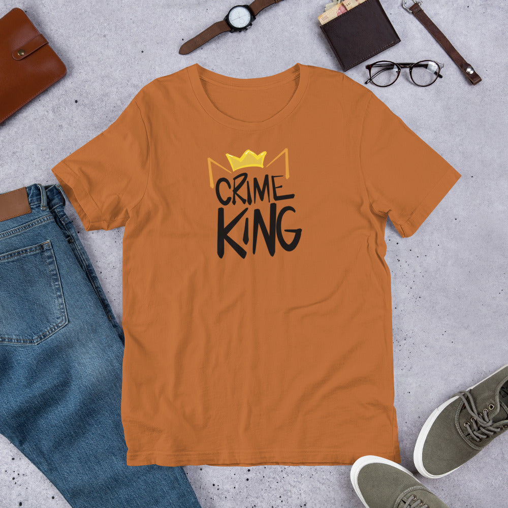 A burnt orange crew neck tee shirt has a pair of orange cat ears and yellow crown sitting on the words, "Crime King" in a bold writing.