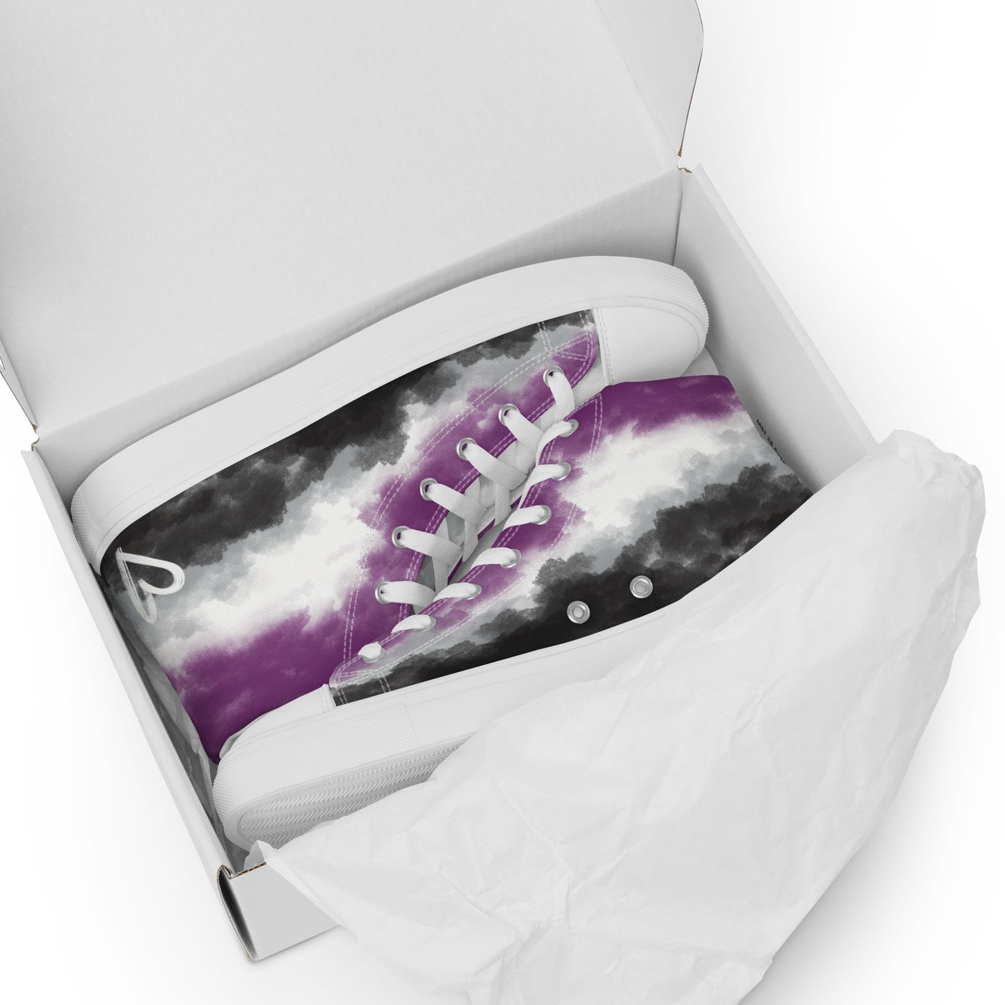 A pair of high top shoes with clouds in the asexual flag colors, a hand drawn white heart on the heel, white laces and accents, and the Aras Sivad Studio logo on the tongue sit in a white box with paper.