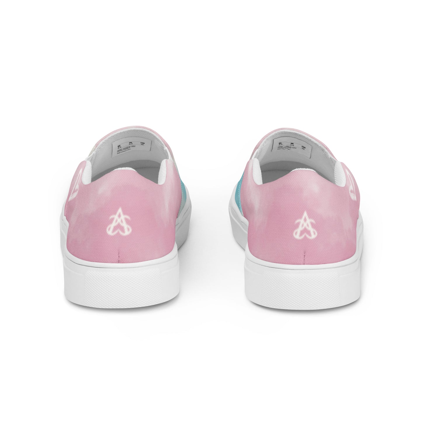 Back view: A pair of slip on shoes has a cloud pattern with color blocked areas of blue, white, and pink, a white doodled heart on the outside, and the Aras Sivad Studio logo on the heel.