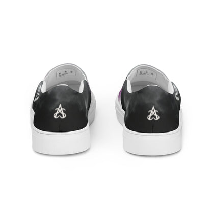 Back view: A pair of slip-on shoes with clouds in the asexual flag colors, a hand drawn white heart on the side, and the Aras Sivad Studio logo on the back.