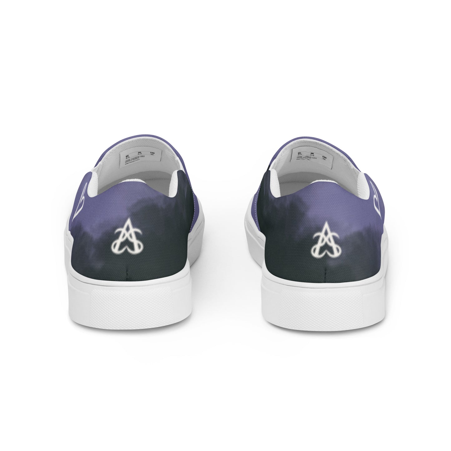 Back view: A pair of slip-on shoes with the non-binary colors in wisps of clouds and the Aras Sivad Studio logo in white on the back.