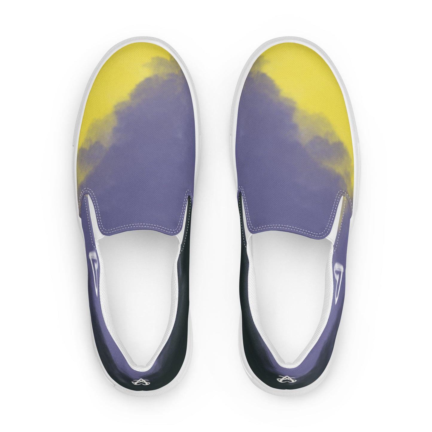 Top view: A pair of slip-on shoes with the non-binary colors in wisps of clouds with a white hand drawn heart on the outside under the ankle and the Aras Sivad Studio logo in white on the back.