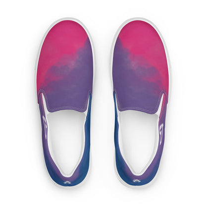 Top view: a pair of slip on shoes with color block pink, purple, and blue clouds, a white hand drawn heart, and the Aras Sivad logo on the back.