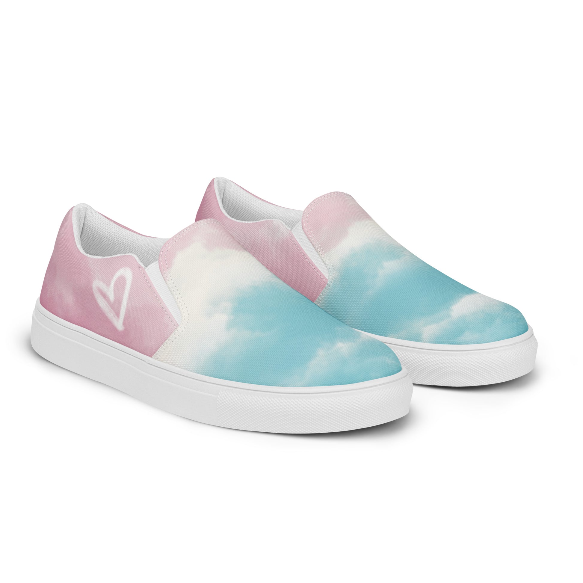 Right front view: A pair of slip on shoes has a cloud pattern with color blocked areas of blue, white, and pink, a white doodled heart on the outside, and the Aras Sivad Studio logo on the heel.