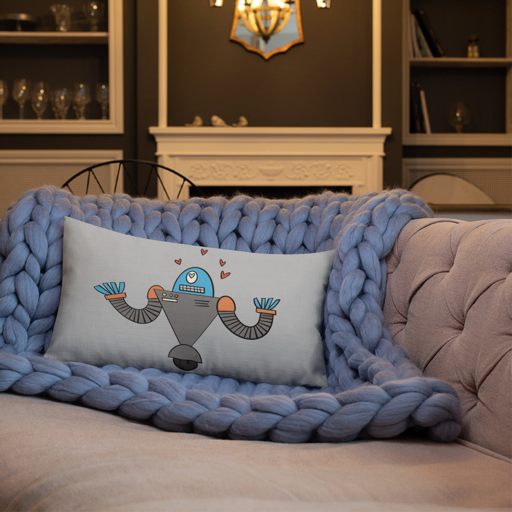 A robot doodle with a "heart eyes" expression has been made into a pillow and is shown on a couch.