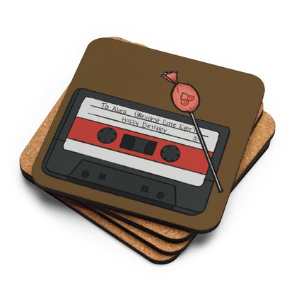 A stack of cork coasters with one on top showing an illustration of a mixtape that says "to Alara, weirdest date ever. Happy birthday"with a cherry lolipop.