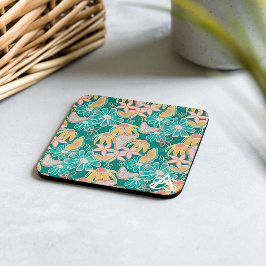 A coaster with an illustration of butterflies and flowers in yellow, pink, and blue by Aras Sivad sits with a basket and a plant.