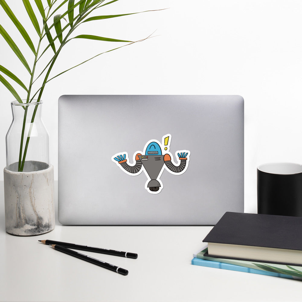 A robot doodle with an excited expression has been made into a sticker and is stuck to a laptop.