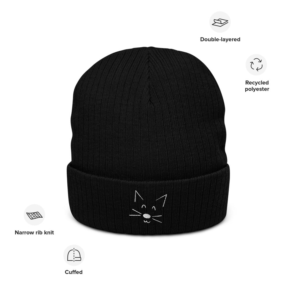 A picture of the black rib knit beanie with a white cat face doodle detail on the cuff. Pictures around show features as listed in the main listing.