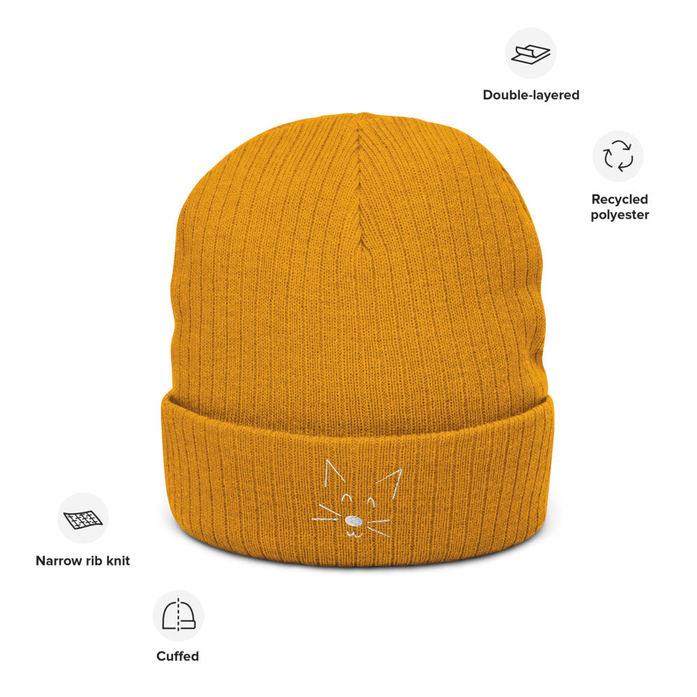 A picture of the mustard yellow rib knit beanie with a white cat face doodle detail on the cuff. Pictures around show features as listed in the main listing.
